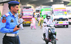 Traffic policemen are at risk of falling prey to vehicles toxic fumes. Tribune photo: Inderjeet Singh 