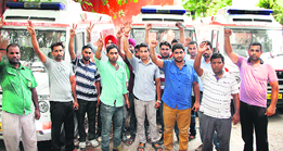 Members of the 108 Emergency Assistants Association, Punjab, hold a protest in Jalandhar on Monday.
