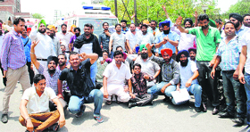 Drivers and pharmacists of the 108 ambulance service hold a dharna in Amritsar on Monday.