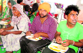 Pilgrims given food on their arrival in Patiala on Sunday.
