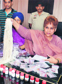 Excise Department staff show the items recovered in Amritsar on Tuesday.