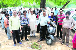 Residents resent the delay in installing number plates on their vehicles at the SDM's office in Chandigarh on Tuesday.