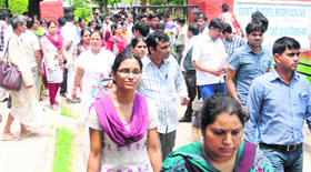 Aspiring teachers come out of an examination centre in Chandigarh after taking the Haryana Teacher Eligibility Test.