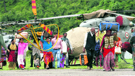 Helicopters bring people evacuated from Badrinath on Tuesday.