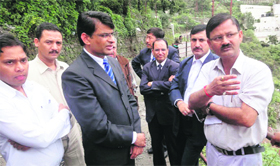 The SDM of Mussoorie (in white shirt) directs officials of Jaypee Hotel after residents complained about waterlogging at Balrowganj