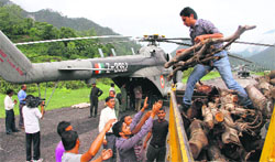 Firewood for cremation of those who died in Kedarnath being lifted on copters. Tribune photo: Vinod Pundir