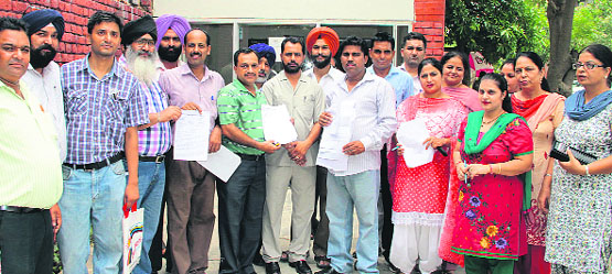 Members of the Master Cadre Union protest against assigning of panchayat poll duties at far-flung places, in Jalandhar on Tuesday. Photo: Sarabjit Singh