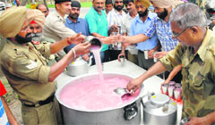 BSF personnel offer sweet water to passersby during a chhabeel in Jalandhar on Tuesday. Tribune Photo: Malkiat Singh