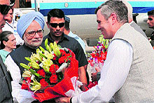 Prime Minister Manmohan Singh being greeted by Chief Minister Omar Abdullah on his arrival at Udhampur Army base station on Tuesday