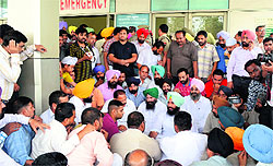 MLA Simarjit Singh Bains and relatives of the victim stage a protest outside Apollo Hospital in Ludhiana