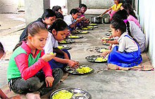 Students of a government school partake of mid-day meal