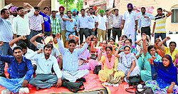 Members of the Rural Health Pharmacists Association hold a protest in front of the zila parishad office in Ludhiana on Tuesday