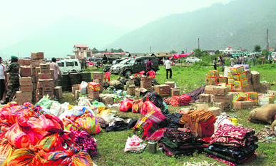 Relief material meant for flood-hits lies at the Gauchar airstrip. 