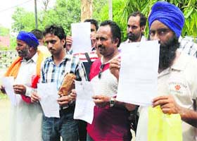 Victims show fake visa documents given to them by the accused in Amritsar on Tuesday