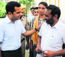 Yadav shares a light moment with a reformed addict. 
