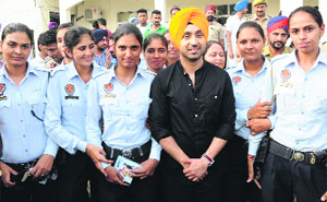 Punjabi singer-turned-actor Diljit Dosanjh with members of the WASPS during a function at the Police Lines in Bathinda on Wednesday.