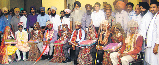 Deputy Commissioner Arun Sekhri along with the members of a society bless couples at the mass marriage in Fatehgarh Sahib on Wednesday.