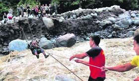 Army personnel rescue pilgrims with the help of a rope bridge at Lambagar in flood-ravaged Uttarakhand on Wednesday