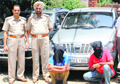 Two members of a gang of vehicle thieves in police custody in Jalandhar on Wednesday. A Tribune photograph