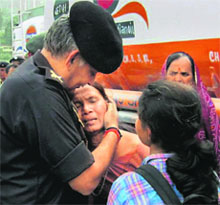 Lt Gen Anil Chait, GOC-in-C, Central Command, consoles rescued pilgrims in Dehradun on Wednesday.