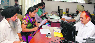 Anxious relatives of Indians residing in the UK inquire about UKs new visa norms at a travel agency in Jalandhar on Wednesday. 