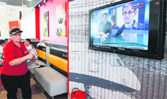 A television at a cafe in Moscows Sheremetyevo airport telecasts news about Edward Snowden on Wednesday.  Reuters
