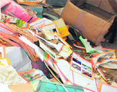 Books eaten up by termites lie scattered on the floor. 