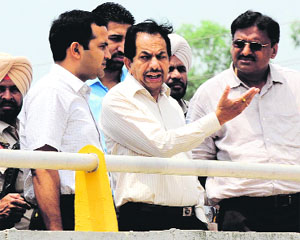 Divisional Commissioner VK Sharma (centre) along with Deputy Commissioner Kamal Kishore Yadav at the railway under bridge on the Mansa road on Thursday. 