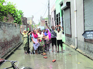 Residents of Parasram Nagar street No. 10 protest against Municipal Corporation officials in Bathinda on Thursday. 