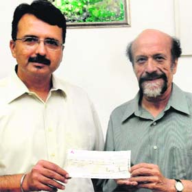 Chandigarh Golf Club captain Sandeep Sandhu (left) and vice-president Virendra Sharma while handing over a cheque for ~10 lakh to The Tribune Trust as part of their contribution to the Prime Minister's National Relief Fund for Uttarakhand in Chandigarh on Thursday