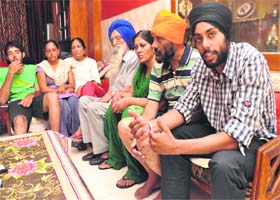 Navjeet (extreme right), a local soccer player, with his family members, after returning from Hemkund Sahib at his residence in Sector 40, Chandigarh, on Thursday