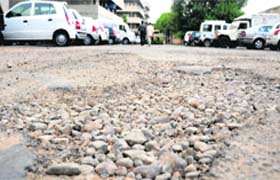 A road in poor shape at a parking lot of the GMCH-32 in Chandigarh