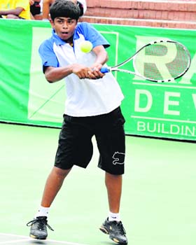 Faisal Qumar returns a shot during the CLTA-AITA Talent Series Tennis Tournament in Chandigarh on Thursday