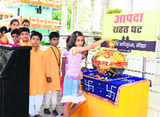 Children donate pocket money for relief aid in the affected regions of Garhwal at Shantikunj in Haridwar on Thursday. 