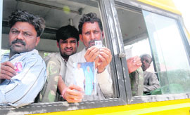 Relatives of missing pilgrims carry their photographs while moving around Dehradun on Thursday. 