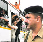 A security personnel looks as yatris leave for the Amarnath yatra in Jammu. Tribune photo 