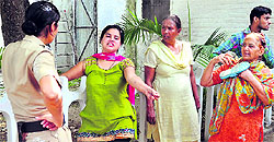 A girl argues with a policewoman near the Police Commissioners office in Ludhiana