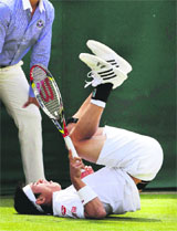 Kei Nishikori of Japan falls as he plays Leonardo Mayer of Argentina in the second round. 