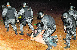 A potester scuffles with riot police during a protest in front of the National Congress in Brasilia on Wednesday