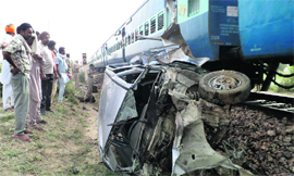 The mangled remains of the car which collided with a train at an unmanned level crossing at Bandi village in Bathinda district on Friday.