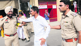 DSP Gurmeet Singh Kingra (left) and Kotwali SHO Karamjit Singh round up a protesting teacher.