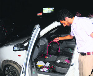 A person shows wires of the music system stolen from his car in front of Centra Mall in Industrial Area, Phase I, Chandigarh, on Friday.