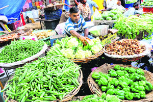 A vendor sells vegetables at the Sector 26 Grain Market in Chandigarh on Friday. 