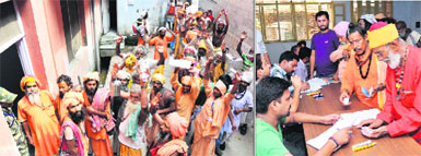 Sadhus queue up and (right) register for the annual Amarnath yatra in Jammu on Friday.