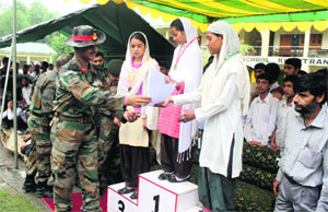 Brigadier AN Jha gives away prizes to the winners of the badminton Tournament in Gundoh on Thursday. 