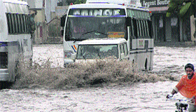 Commuters face a tough time crossing the Jalandhar-Kapurthala road inundated by rainwater.