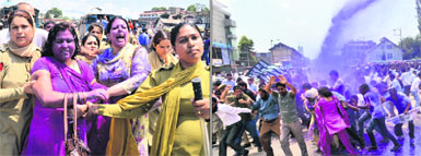 Policewomen detain ReT teachers; (right) water cannons being used to disperse the protesting ReT teachers in Srinagar on Friday. 