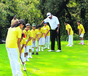 Vikram Sethi, a golf professional, imparts training to schoolchildren in Srinagar on Friday.