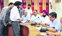 Officials auction vanity numbers in Ludhiana on Friday. Photo: Inderjeet Verma