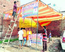 Akali activists prepare a rally venue at Dayanand Nagar village in Amritsar on Friday.